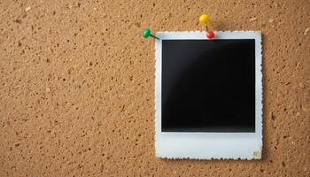 Blank photo frame on cork board with colorful push pins attached