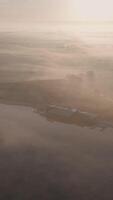 A foggy morning view of a farm and water video