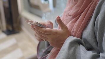 Engaging with a smartphone while seated in a stylish setting video