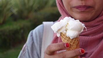 Enjoying ice cream cone in a sunny outdoor setting video