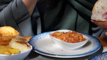 Enjoying traditional dish with bread and savory sauce in local eatery video