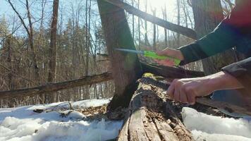 A person cutting a piece of wood with a knife video