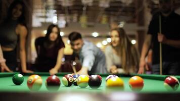 Friends joyfully play billiards. 2 video