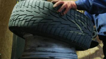 Change a tyre, Car mechanic is changing a tyre in a garage auto service video