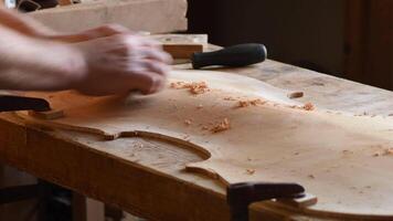 Luthier working in the structure of a new cello or violoncello video