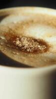 Perfectly stirred coffee with sugar captured in close-up view video