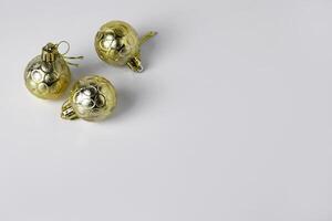 Top view of three gold Christmas ball ornaments with textured designs photo