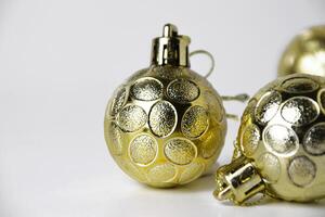 Closeup of three gold Christmas ornaments with textured details photo