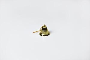 Shiny Gold Christmas Bell Decoration Dangling from a Thin Gold String photo