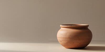 Rustic Clay Pot with Rounded Shape and Smooth Surface Ideal for Garden or Home Decoration. photo