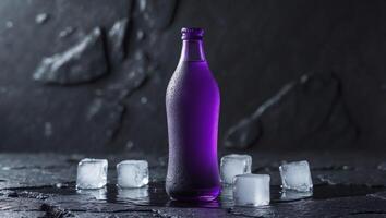 Purple Beverage Bottle with Ice Cubes on a Dark Textured Background in a Studio Setting. photo