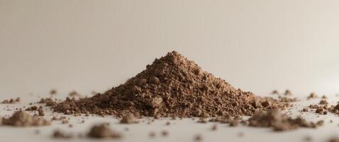 A pile of brown powder on a white background photo