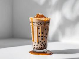 A glass of bubble tea with caramel drizzle photo