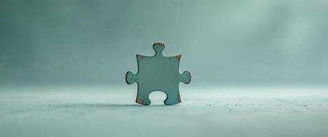 Completing a puzzle piece on a teal background photo