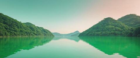 A green lake surrounded by mountains and trees photo