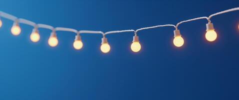 A bunch of lights hanging from a string on a blue background photo