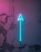 Neon arrow pointer on a grunge texture wall. photo