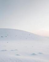 A lone person walking across a snowy field photo