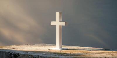 White cross on stone base illuminated by soft sunlight and shadows. photo