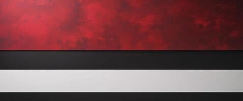 A tight shot of a red and black background featuring a white and black horizontal band at the picture's base photo