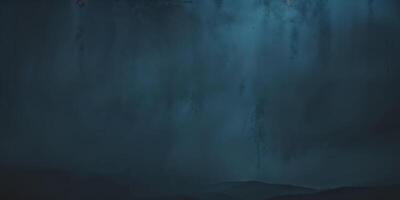 A dark cave with a waterfall and a man standing in front of it photo
