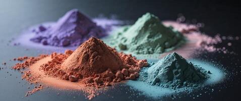Three different colored powders on a black surface. photo