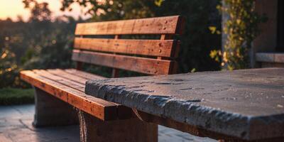 A bench and a table sitting on a stone patio photo