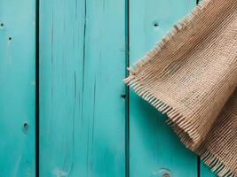 Rustic Burlap Texture on Turquoise Wooden Background photo