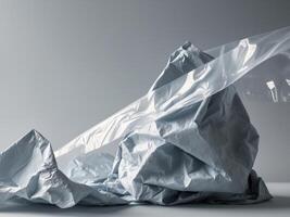 Tilted angle gradient gray plastic wrap overlay backdrop crumpled and draped textured cellophane material. photo