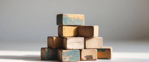 Stack of worn toy blocks in natural light. photo