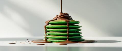 A stack of pancakes with chocolate drizzle on top photo