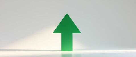 Green upward arrow pointing up representing growth and success photo