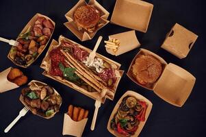 Top view of ,table with ,food on it. Meat, vegetables, French fries, burger, mushrooms photo