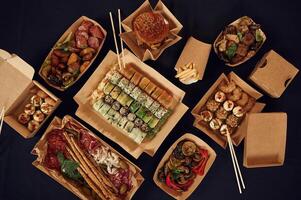 Top view of table with food ,on it. Meat,, vegetables, sushi, French fries, burger, mushrooms photo
