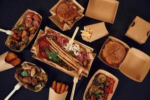 Top view of table with, food on it. Meat, vegetables, French fries, burger, mushrooms photo