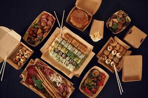 Top view of, table, with food on it. Meat, vegetables, sushi, French fries, burger, mushrooms photo