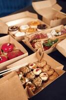 Close up, view of table with, food on it. Meat, vegetables, sushi, French fries, burger, mushrooms photo