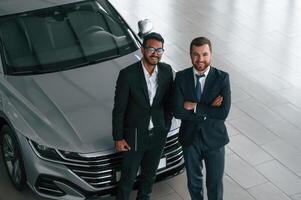View, from the ,top. Two businessmen are working together in the car showroom photo