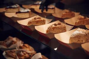 Close ,up view of man's hands in gloves that taking delicious desserts photo