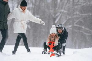 Sled ride. Happy ,family is, outdoors, enjoying snow time at winter together photo