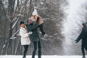 Active people. Happy family, is outdoors, enjoying snow time at winter together photo