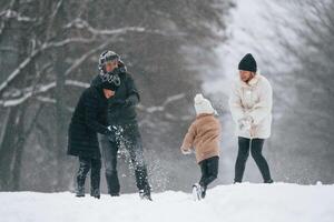 Active, people. Happy, family is outdoors, enjoying snow time at winter together photo