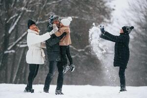 Active people.. Happy family is outdoors, enjoying snow time at winter together photo
