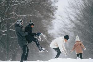 Playing ,snowballs. Happy family is outdoors, enjoying snow time at winter together photo