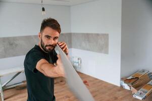 Plank, is in, the hands. Man is installing new laminated wooden floor photo