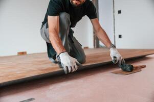 Hand, work. Man, is installing new laminated wooden floor photo
