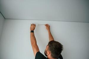 Man is working with lighting equipment, indoors at domestic room photo
