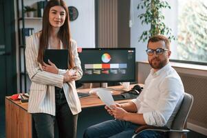 Creative, job. Two designers are working together in the modern office photo