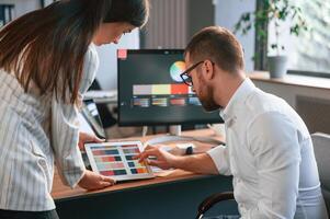 Creative job.. Two designers are working together in the modern office photo