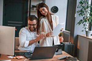 Two ,employees are working together in the modern office photo
